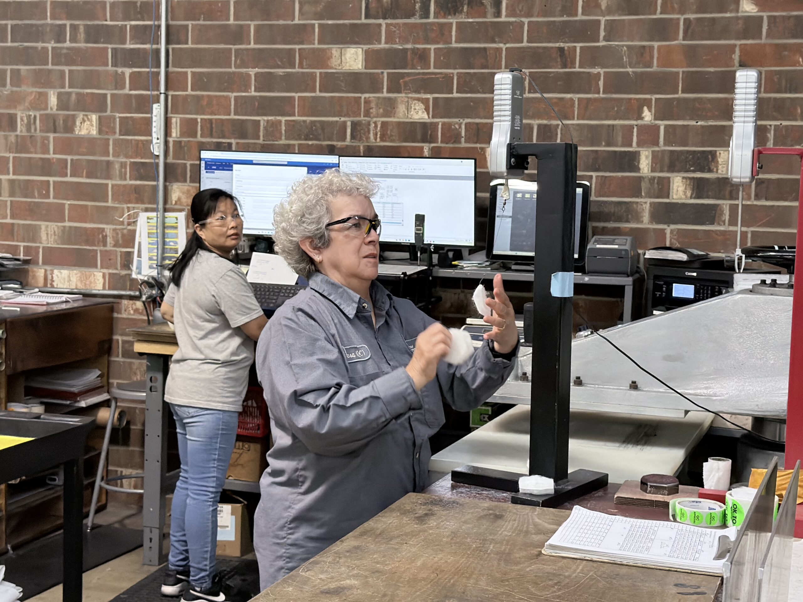Two women work in a warehouse.